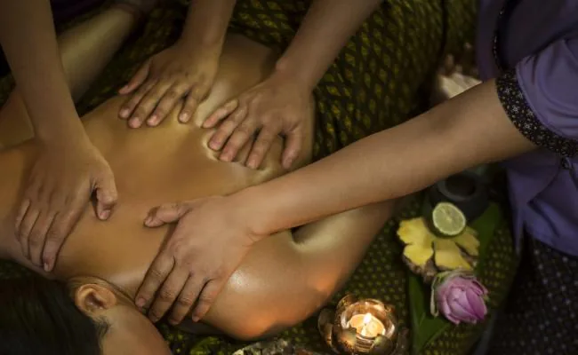 Four hands massage — two therapists working in synchronised pairs at Massage Eden Auckland CBD
