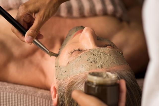 Woman getting a mud mask.