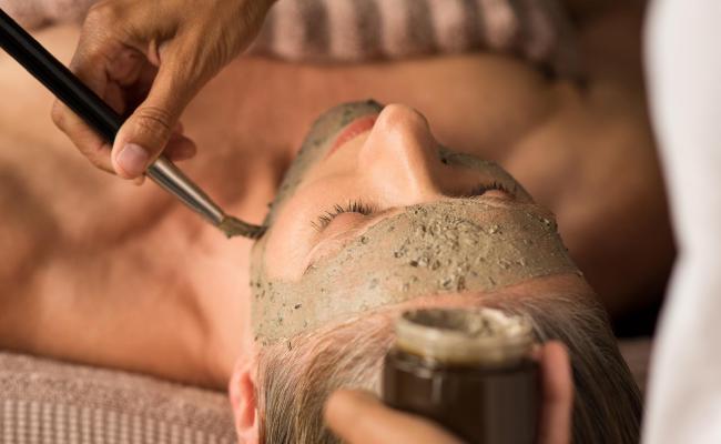 Woman getting a mud mask.